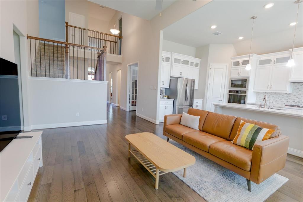 3920 Bentgrass Road Plano, TX 75023 - Photo 16 of 30 a living room with furniture and a wooden floor