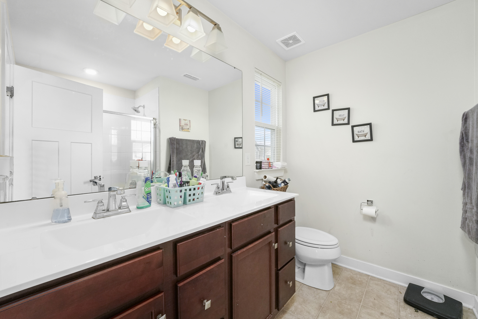 3413 Forestview Drive Joliet, IL 60431 - Photo 16 of 32 a bathroom with a double vanity sink toilet and mirror