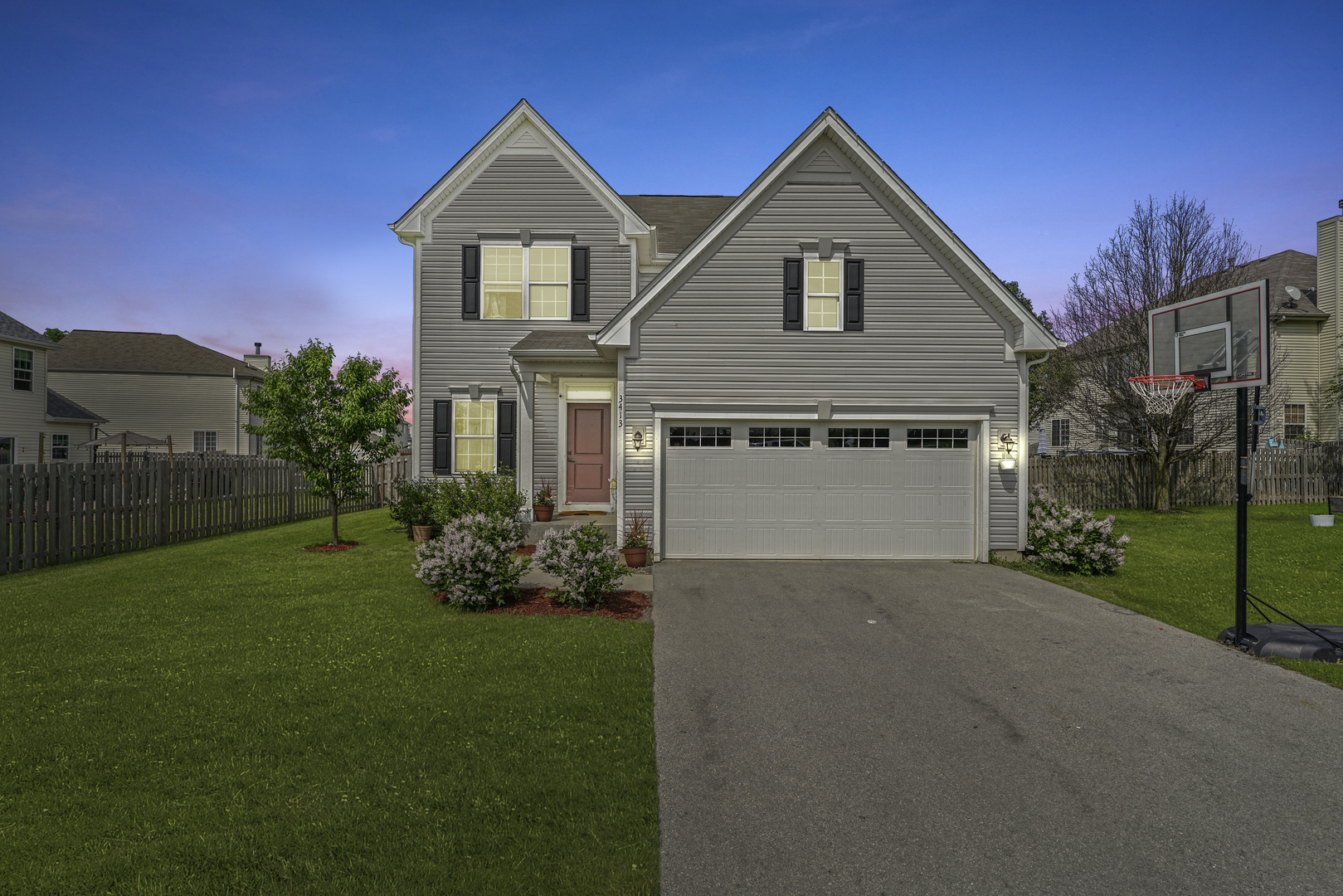 3413 Forestview Drive Joliet, IL 60431 - Photo 2 of 32 a front view of a house with a yard and garage