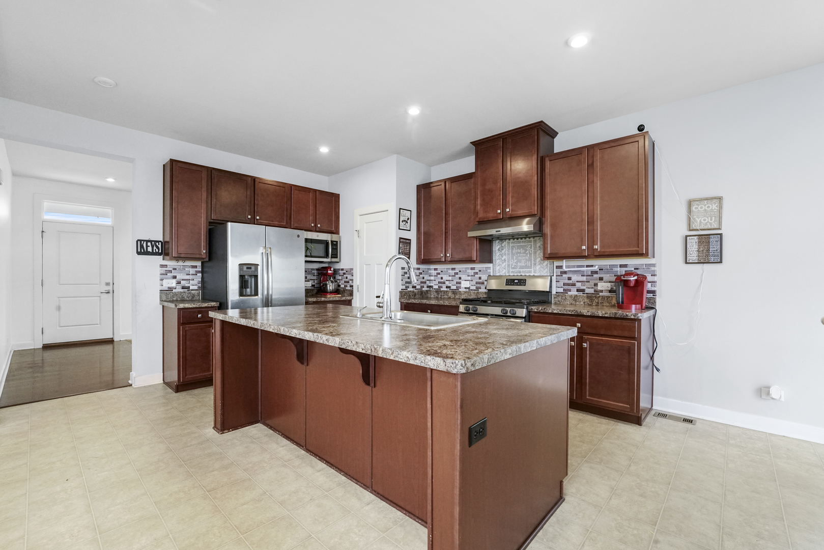 3413 Forestview Drive Joliet, IL 60431 - Photo 5 of 32 a kitchen with stainless steel appliances granite countertop a stove refrigerator sink and cabinets