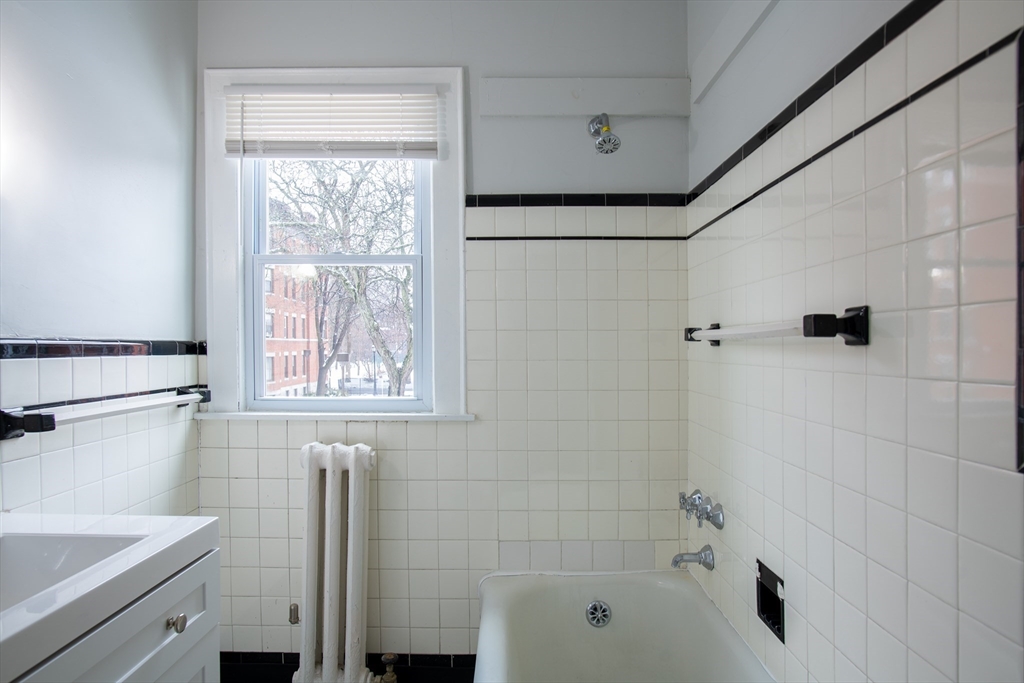 69 Winter Street Springfield, MA 01105 - Photo 13 of 36 a bathroom with a bathtub and a shower