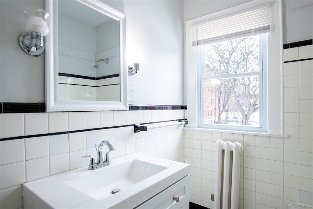 69 Winter Street Springfield, MA 01105 - Photo 14 of 36 a bathroom with a sink and a mirror