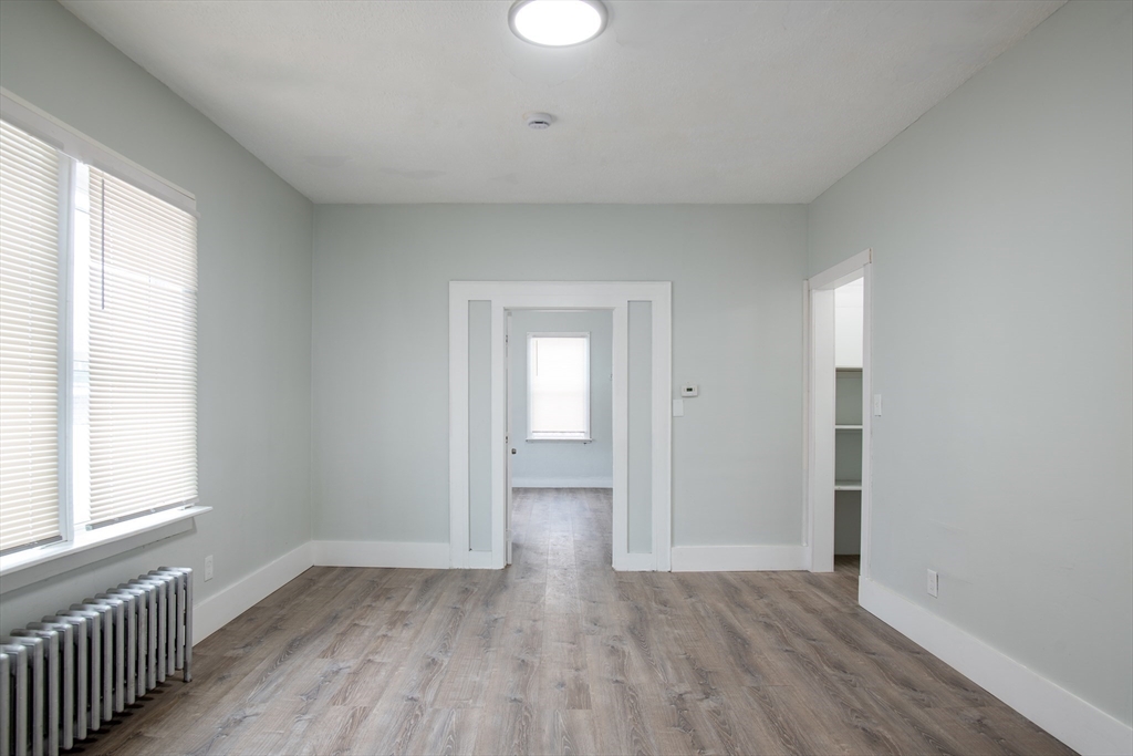 69 Winter Street Springfield, MA 01105 - Photo 18 of 36 a view of empty room with wooden floor and fan