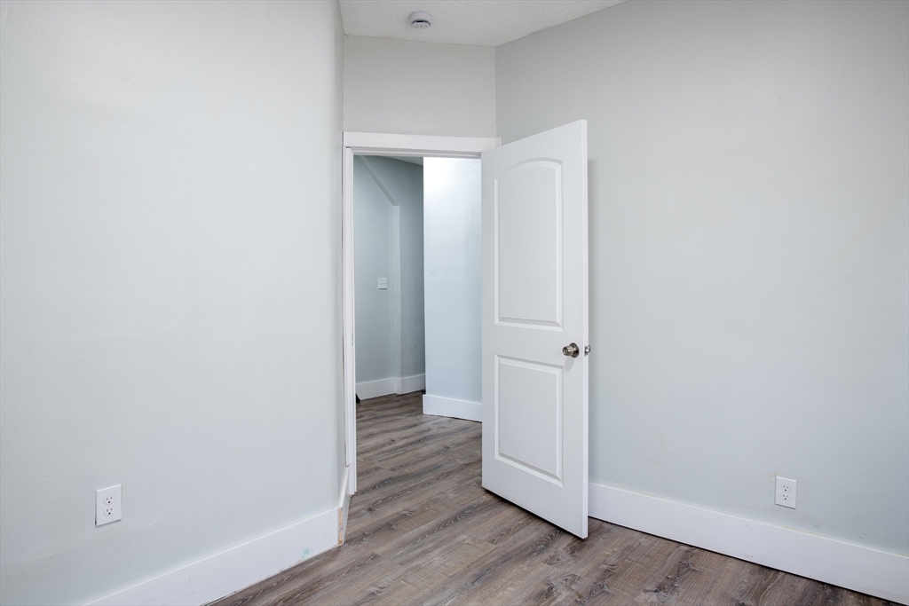 69 Winter Street Springfield, MA 01105 - Photo 23 of 36 a view of a hallway with wooden floor