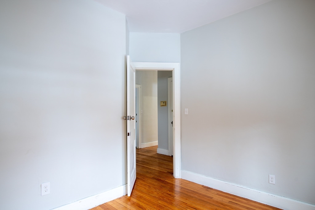 69 Winter Street Springfield, MA 01105 - Photo 28 of 36 a view of a hallway with wooden floor