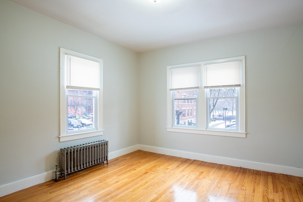 69 Winter Street Springfield, MA 01105 - Photo 29 of 36 a view of an empty room with wooden floor and a window