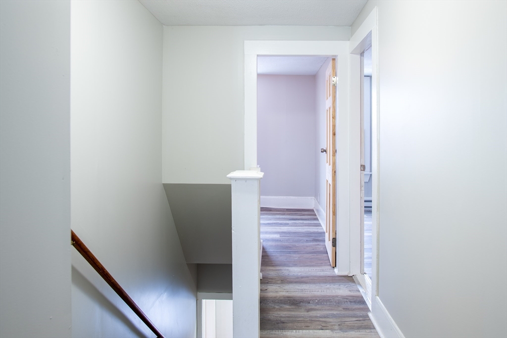 69 Winter Street Springfield, MA 01105 - Photo 35 of 36 a view of a hallway with wooden floor and staircase