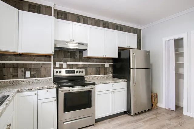 a kitchen with a stove a refrigerator and a sink