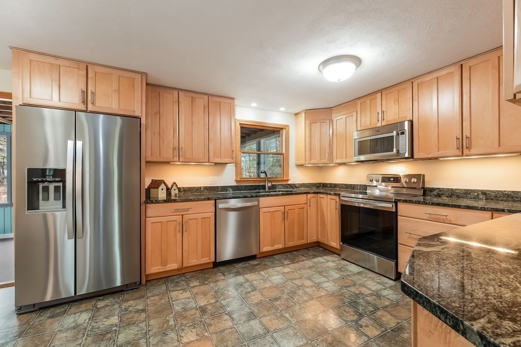 9 Eaton Road Framingham, MA 01701 - Photo 12 of 34 a kitchen with granite countertop a refrigerator stove top oven and sink