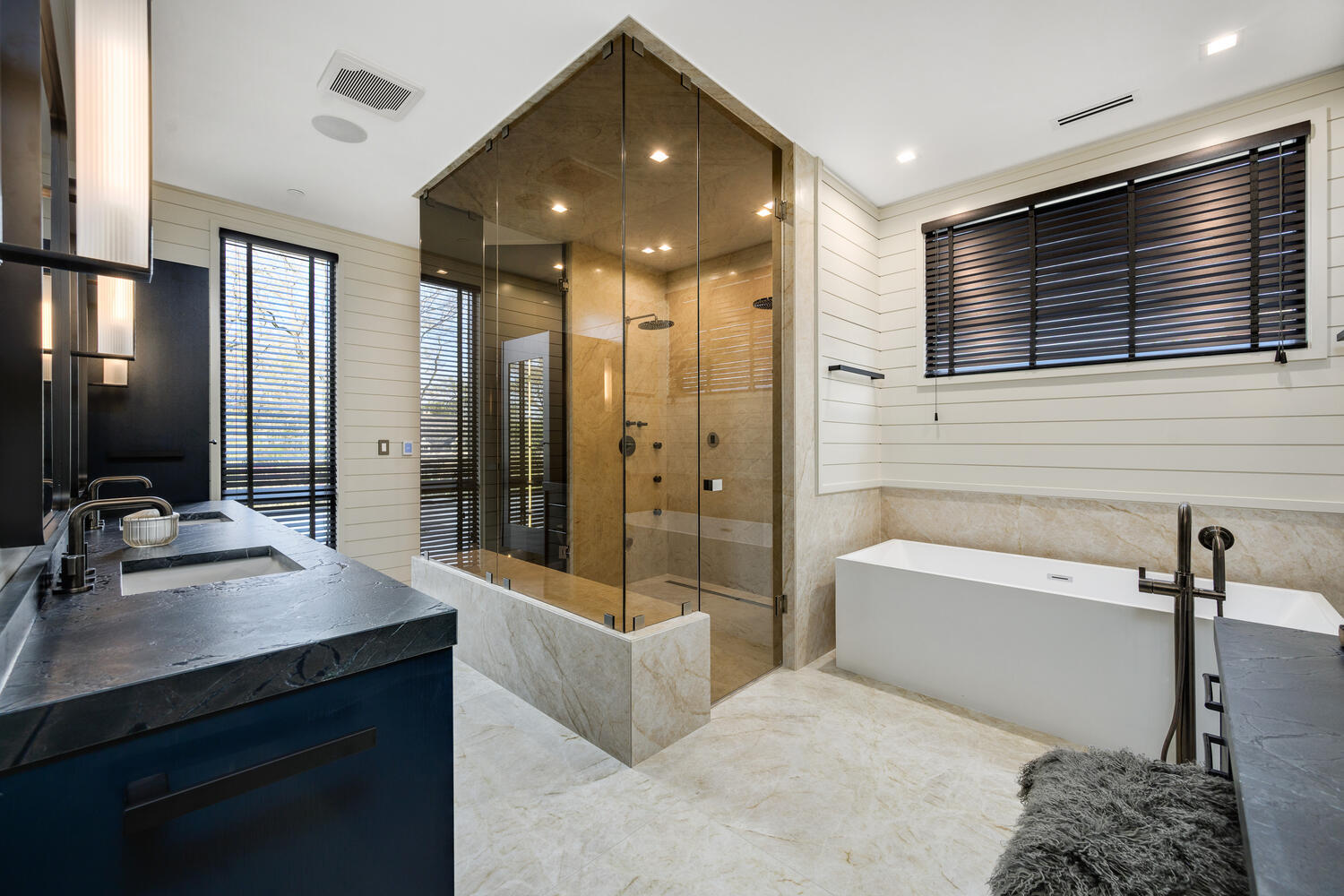 921 Sheridan Road Glencoe, IL 60022 - Photo 20 of 51 a bathroom with a double vanity sink a mirror and a bathtub