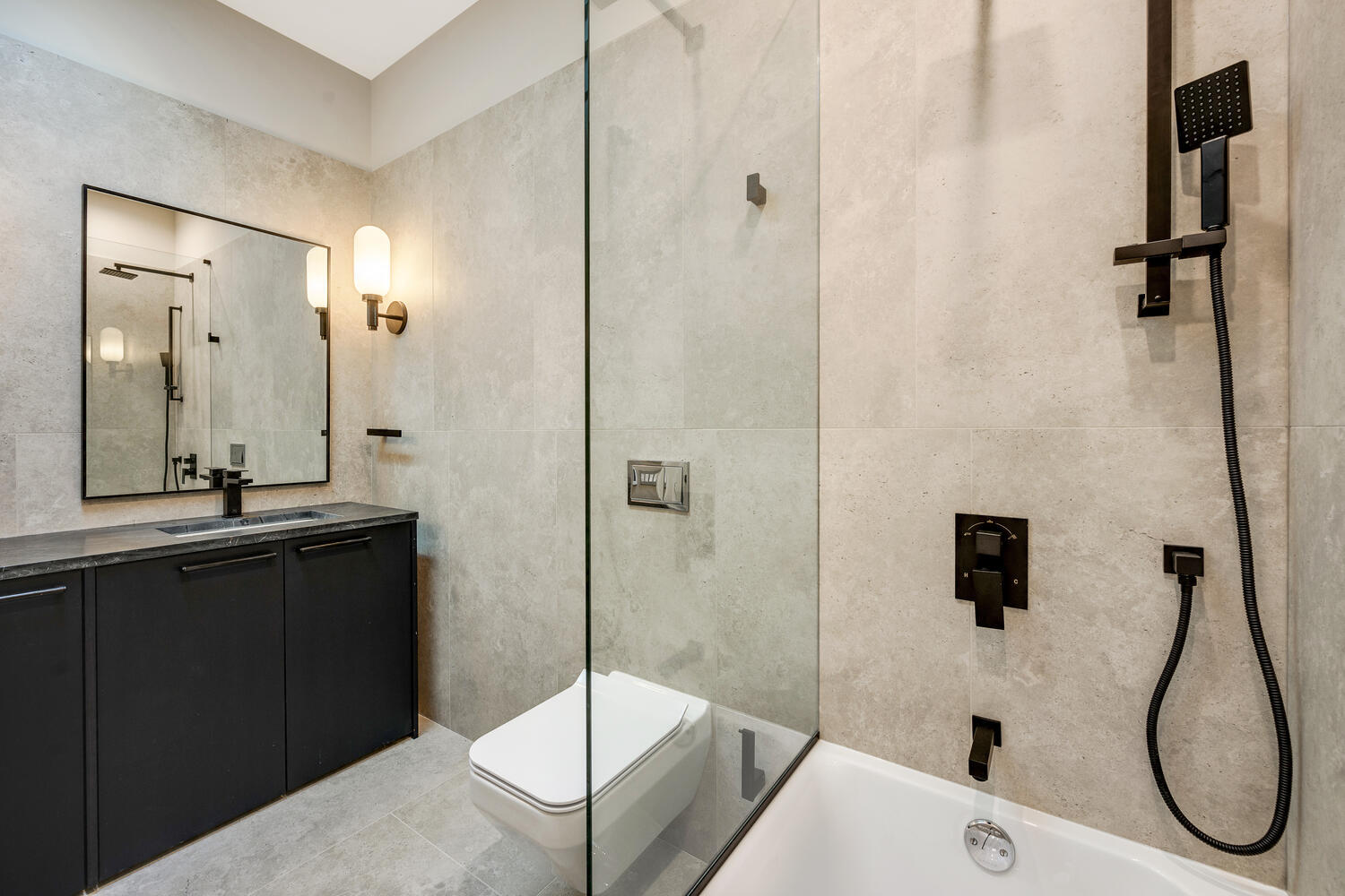 921 Sheridan Road Glencoe, IL 60022 - Photo 29 of 51 a bathroom with a granite countertop sink a mirror and shower