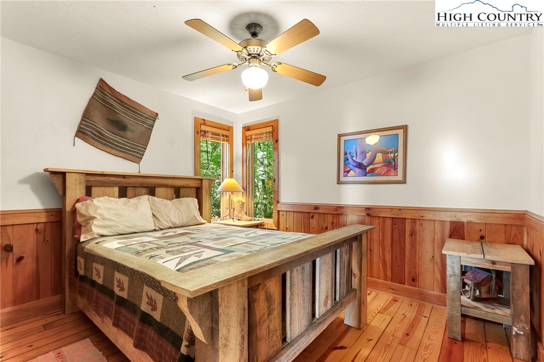 2095 Elk Ridge Road Ferguson, NC 28624 - Photo 18 of 47 a bed room with a bed and a chandelier