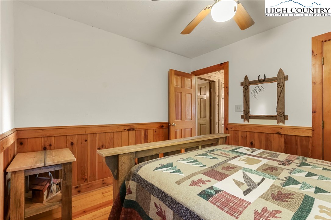 2095 Elk Ridge Road Ferguson, NC 28624 - Photo 19 of 47 a bedroom with a bed and a large mirror on dresser