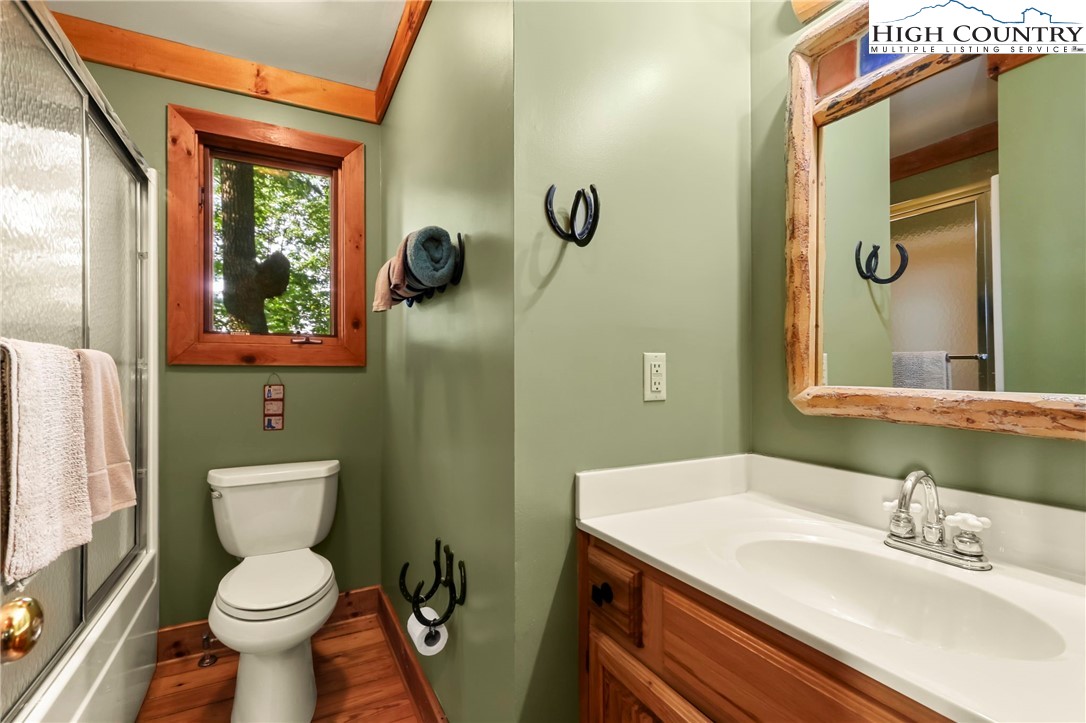 2095 Elk Ridge Road Ferguson, NC 28624 - Photo 21 of 47 a bathroom with a toilet a sink and mirror