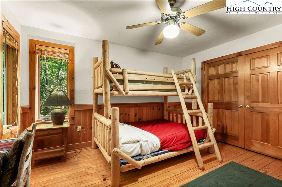 2095 Elk Ridge Road Ferguson, NC 28624 - Photo 22 of 47 a bedroom with a bed and a chandelier