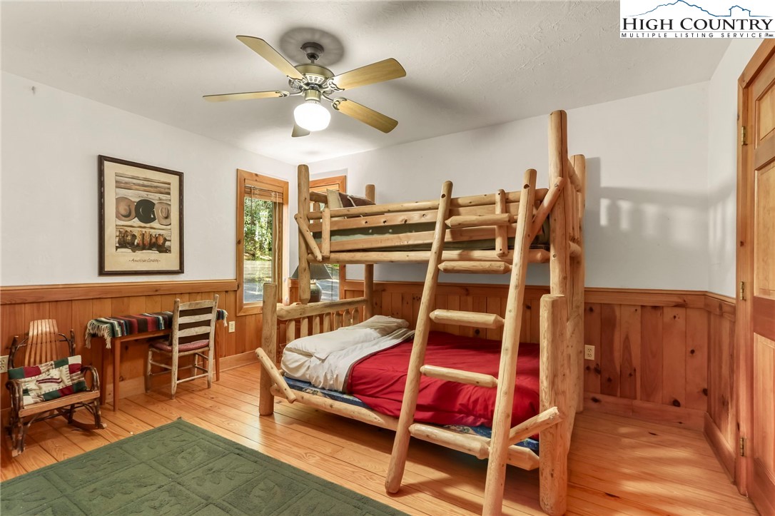 2095 Elk Ridge Road Ferguson, NC 28624 - Photo 23 of 47 a bedroom with furniture window and wooden floor