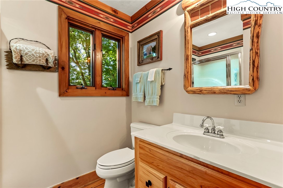 2095 Elk Ridge Road Ferguson, NC 28624 - Photo 31 of 47 a bathroom with a granite countertop sink and a toilet