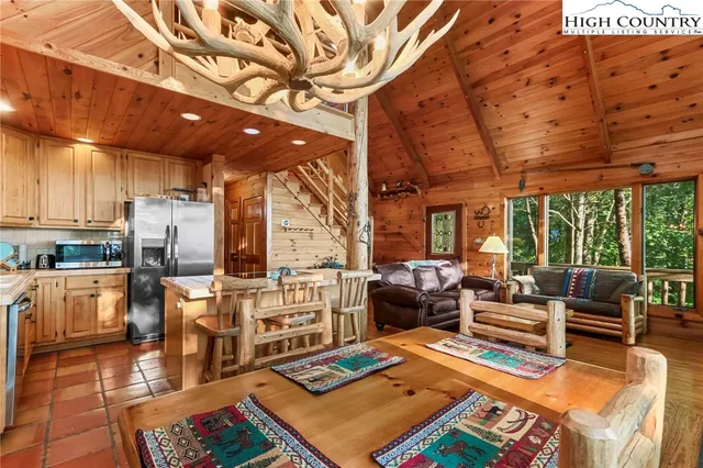 a living room with chairs and a fireplace