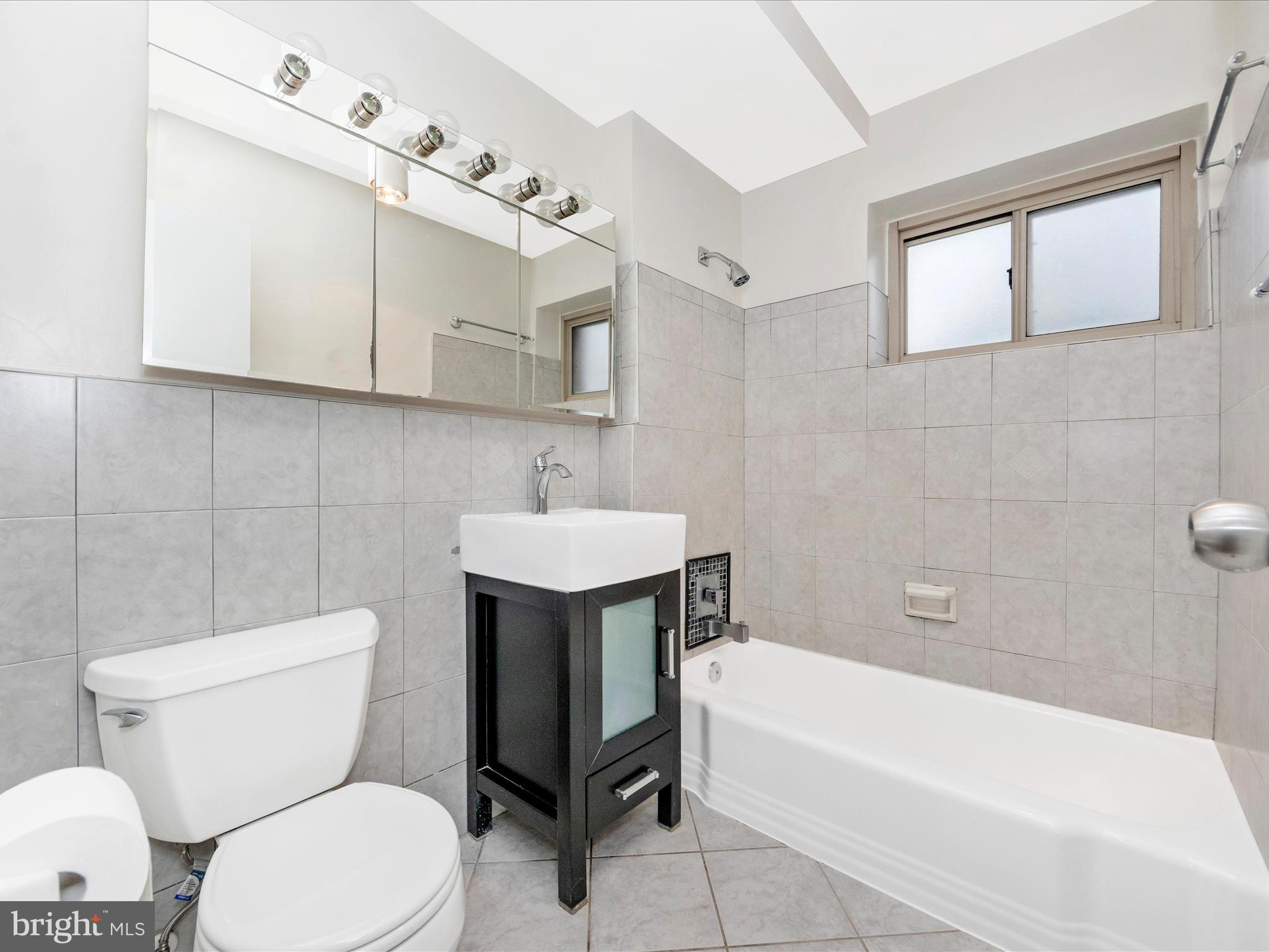 3900 Tunlaw Road Northwest, Unit 104 Washington, DC 20007 - Photo 18 of 36 Bathroom with soaking tub and shower.