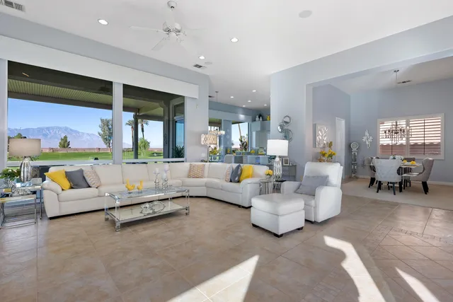 a kitchen with kitchen island stainless steel appliances a table and chairs in it