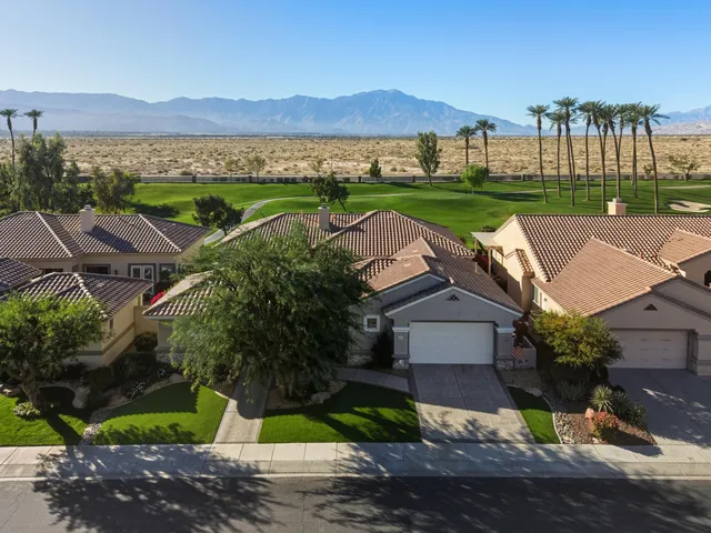 an aerial view of a house with outdoor space and street view