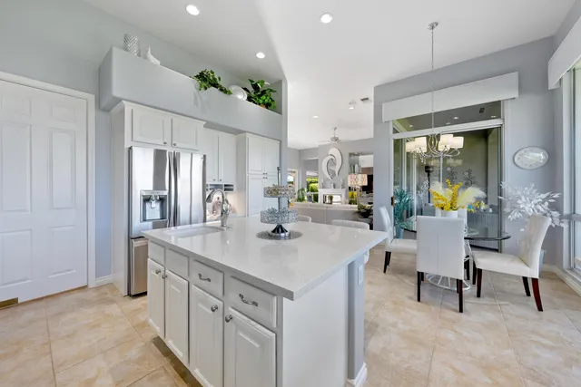 a dining room filled with furniture and a floor to ceiling window
