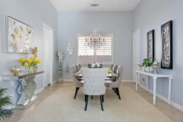 a living room with furniture a flat screen tv and a large window