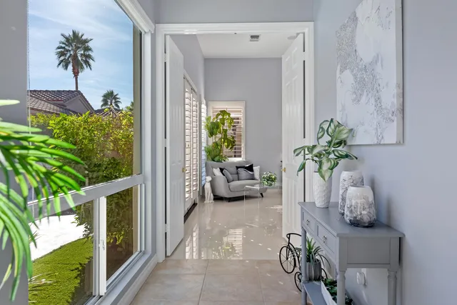 a bedroom with furniture and a large window