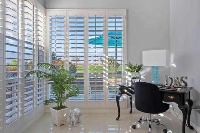 a large white bathroom with a large tub sink vanity and granite
