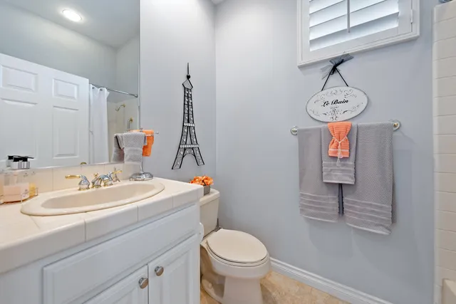 a view of a patio with table and chairs potted plants with floor to ceiling window and potted plants