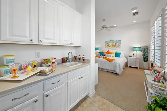 a bedroom with a bed and a chandelier