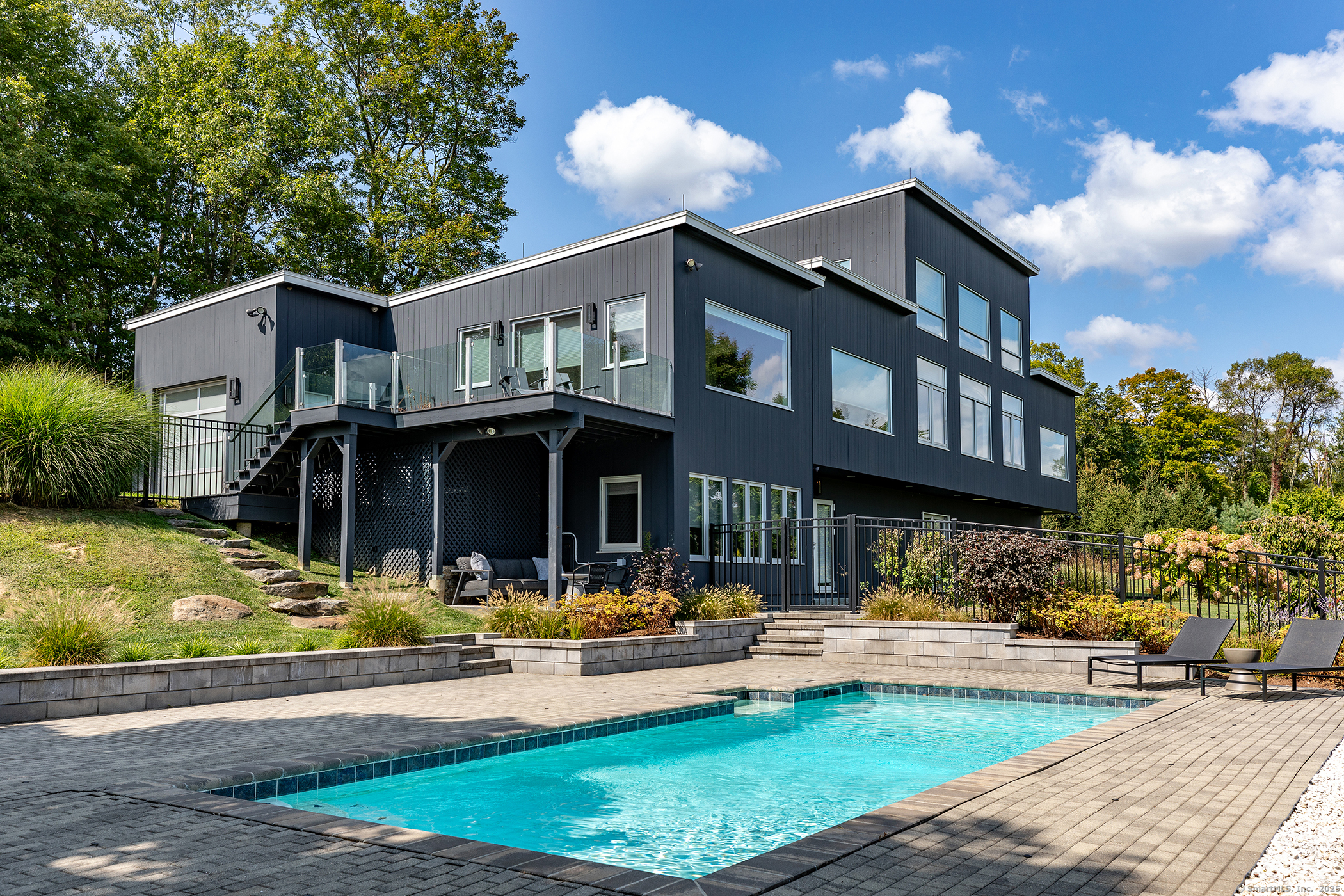 a front view of a house with swimming pool and a yard