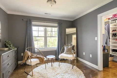 a bedroom with a bed and a chair