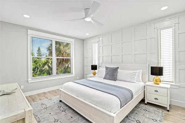 a bathroom with a granite countertop sink a toilet a shower and a mirror