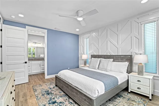 a bedroom with a bed and a view of living room