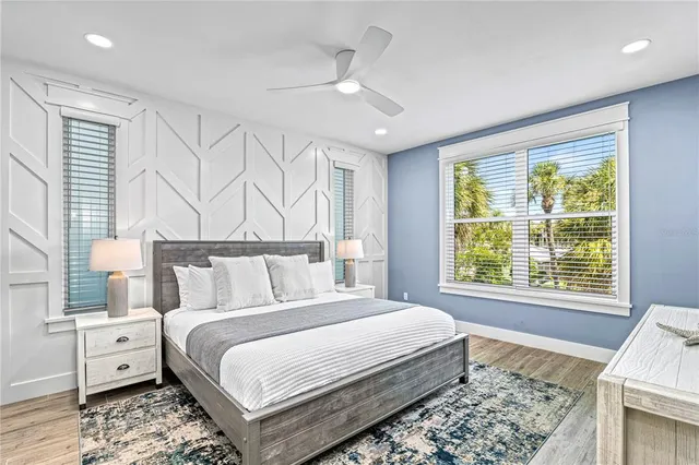 a bedroom with a large bed and a large window