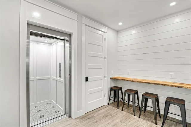 a kitchen with stainless steel appliances a stove a sink and white cabinets