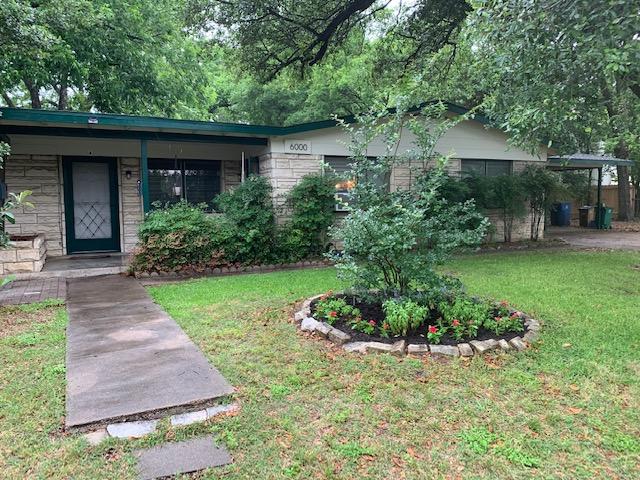 6000 Grover Avenue, Unit A Austin, TX 78757 - Photo 2 of 18 Single story home with a front yard, stone siding, and covered porch