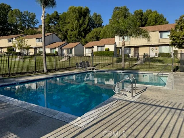 a kitchen with stainless steel appliances granite countertop a sink a stove a refrigerator a washer dryer and a refrigerator