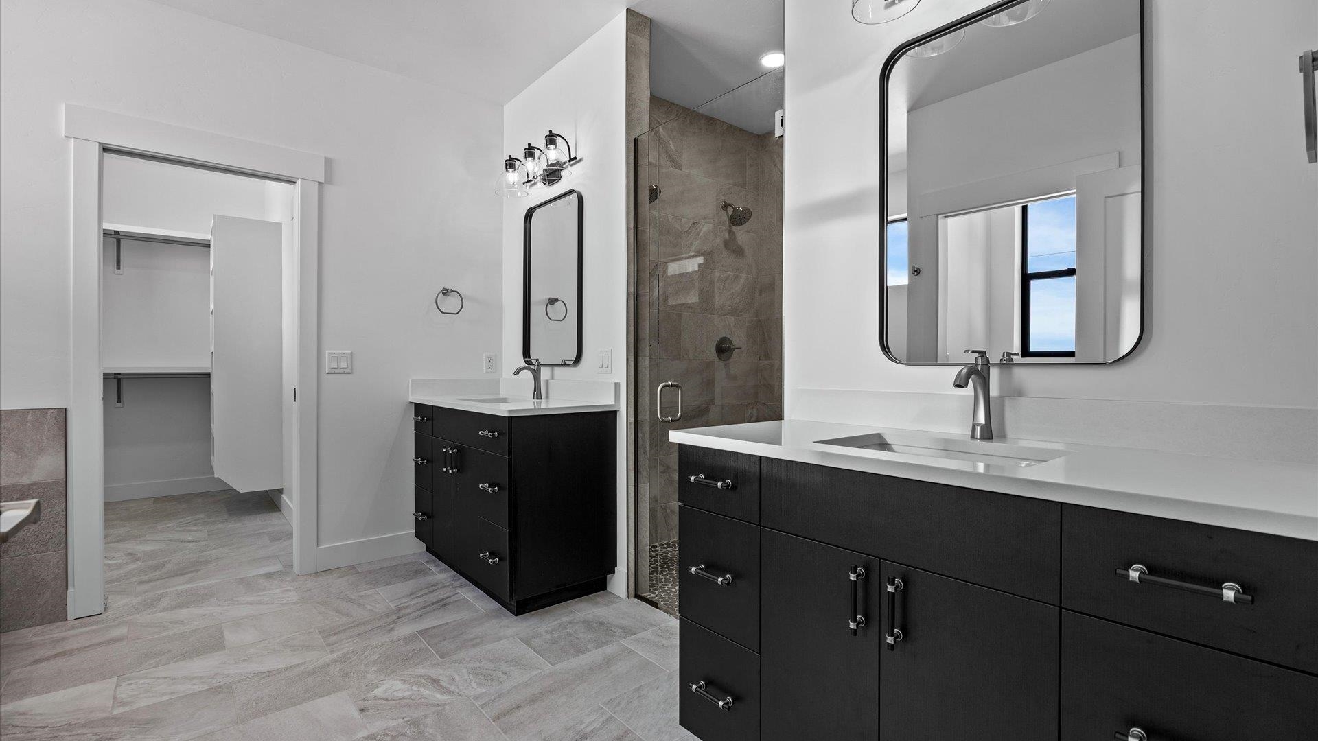 2045 Caleb Street Grand Junction, CO 81507 - Photo 19 of 42 a bathroom with a double vanity sink a mirror and a shower