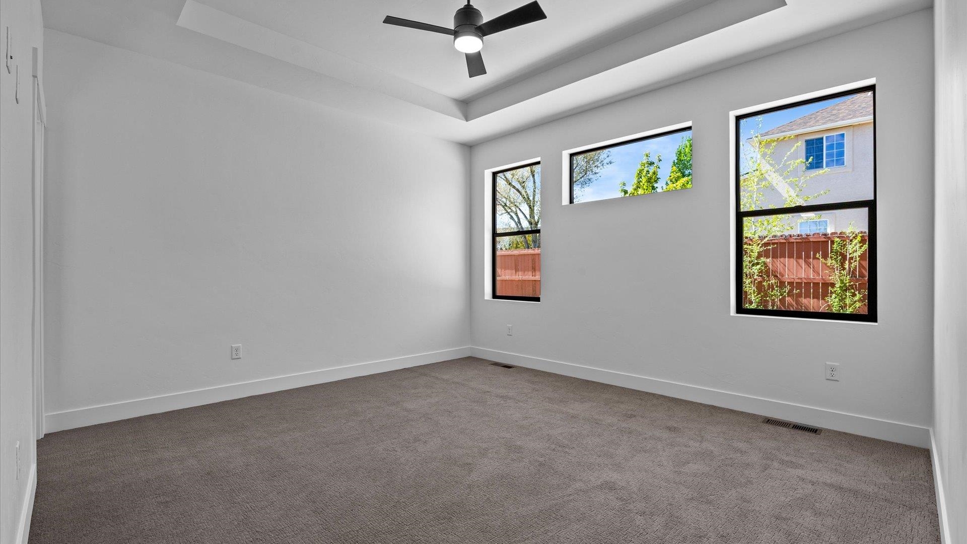 2045 Caleb Street Grand Junction, CO 81507 - Photo 23 of 42 an empty room with windows and ceiling fan