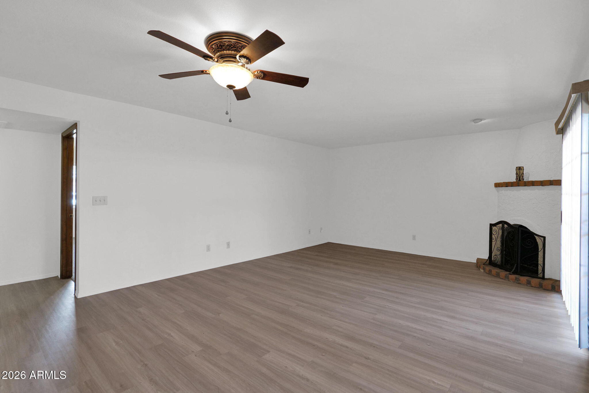 507 West Knox Road Chandler, AZ 85225 - Photo 4 of 34 an empty room with wooden floor a ceiling fan and windows
