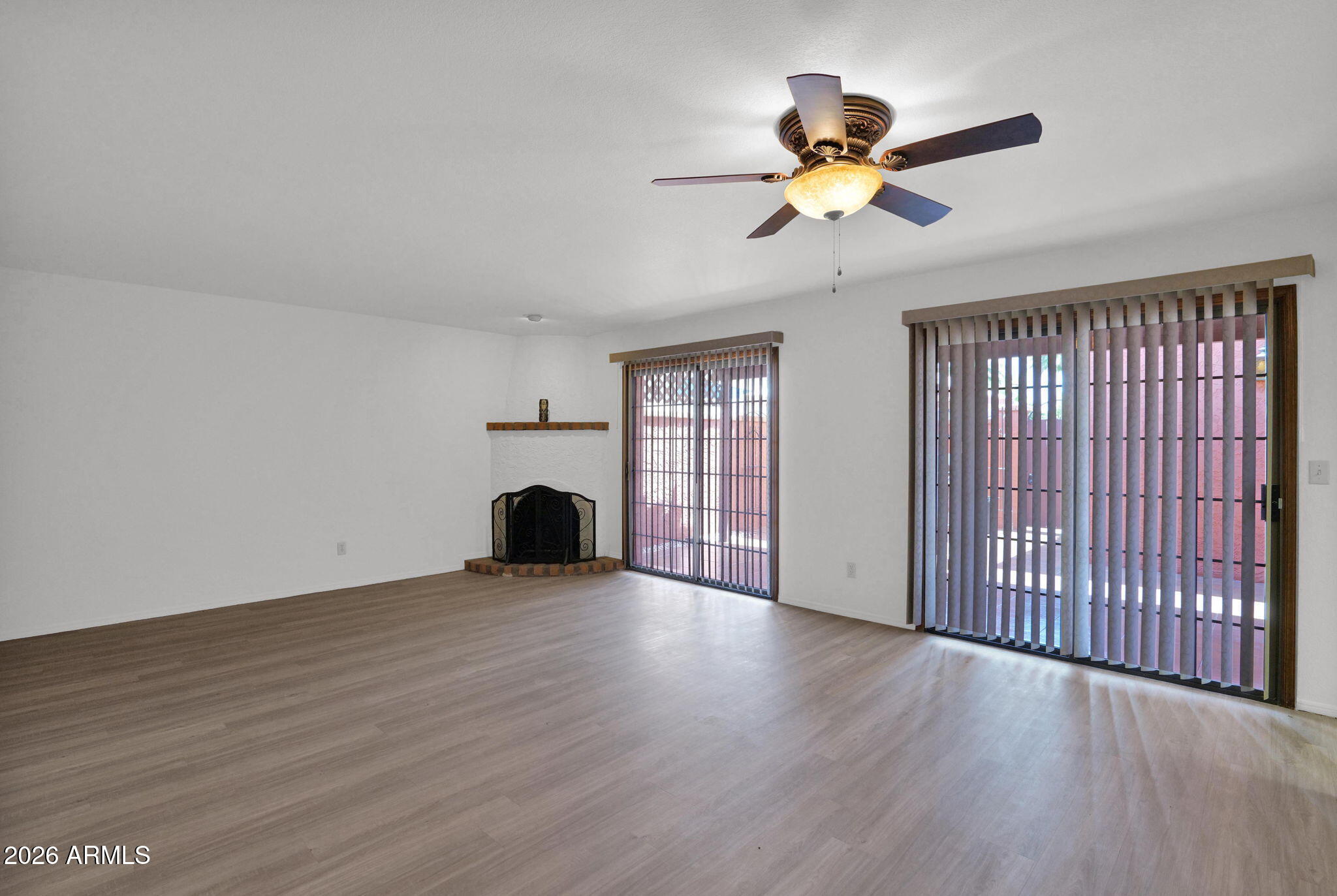 507 West Knox Road Chandler, AZ 85225 - Photo 6 of 34 a view of an empty room with wooden floor and a window