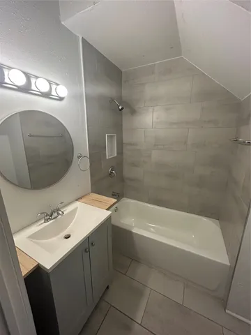 a bathroom with a sink a toilet and bathtub