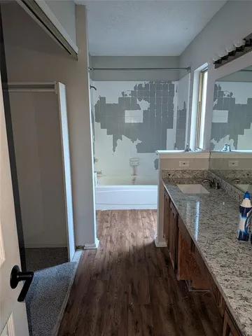 a white toilet sitting next to a bath tub