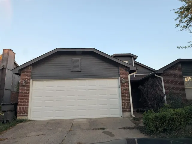 a front view of a house with garage