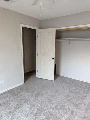a view of an empty room and closet area