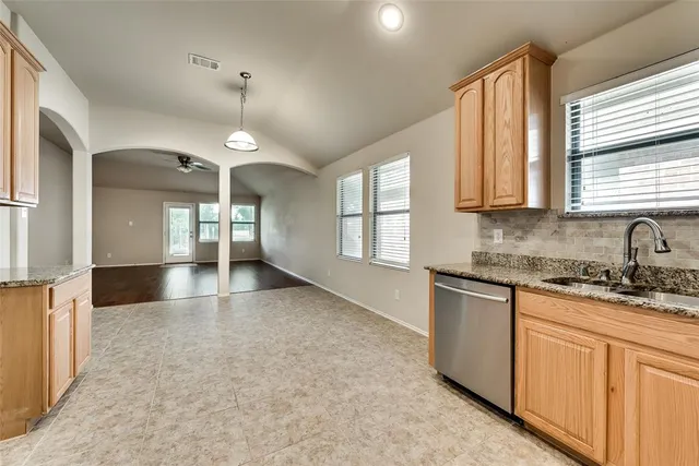 a view of a kitchen with a sink and a window