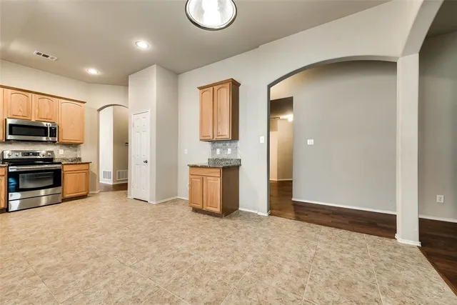 a view of kitchen appliances and cabinets
