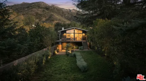 a view of a house with a backyard